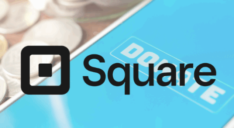 square logo overlaid on a cell ohne with loose change on a table