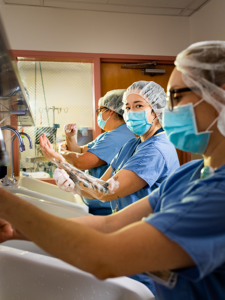 Sam Comen, Rebecca Melchor, Sandra Ceja, and Karina Franco, Surgical Technologist and RNs, Harbor-UCLA Medical Center from the series The Longest Shift, 2021; Digital photograph, 36 x 27 inches; Courtesy of the artist.