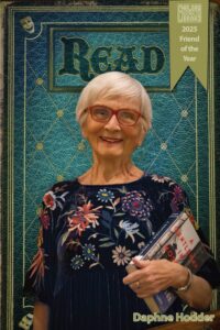 Image of Daphne Hodder with 2025 Friend of the Year banner on a classic teal background with the word READ across the top