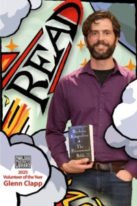 IMmage of Glenn Clapp the 2025 Volunteer of the Year on a poster with a rocket graphic where the letters READ form the rocket shape.
